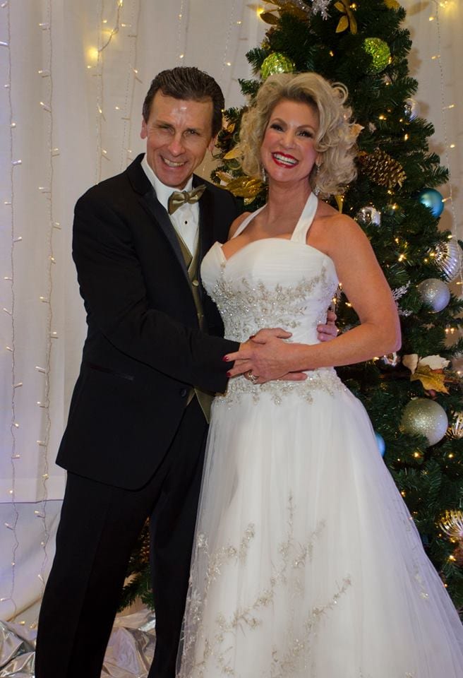 a man in a tuxedo standing next to a woman in a wedding dress