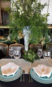 a table set with place settings and flowers