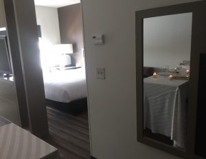 a bedroom with a bed and a mirror in it