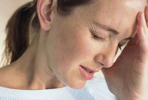 a woman is holding her head in her hands
