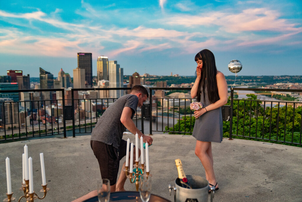 a man and woman standing on top of a roof