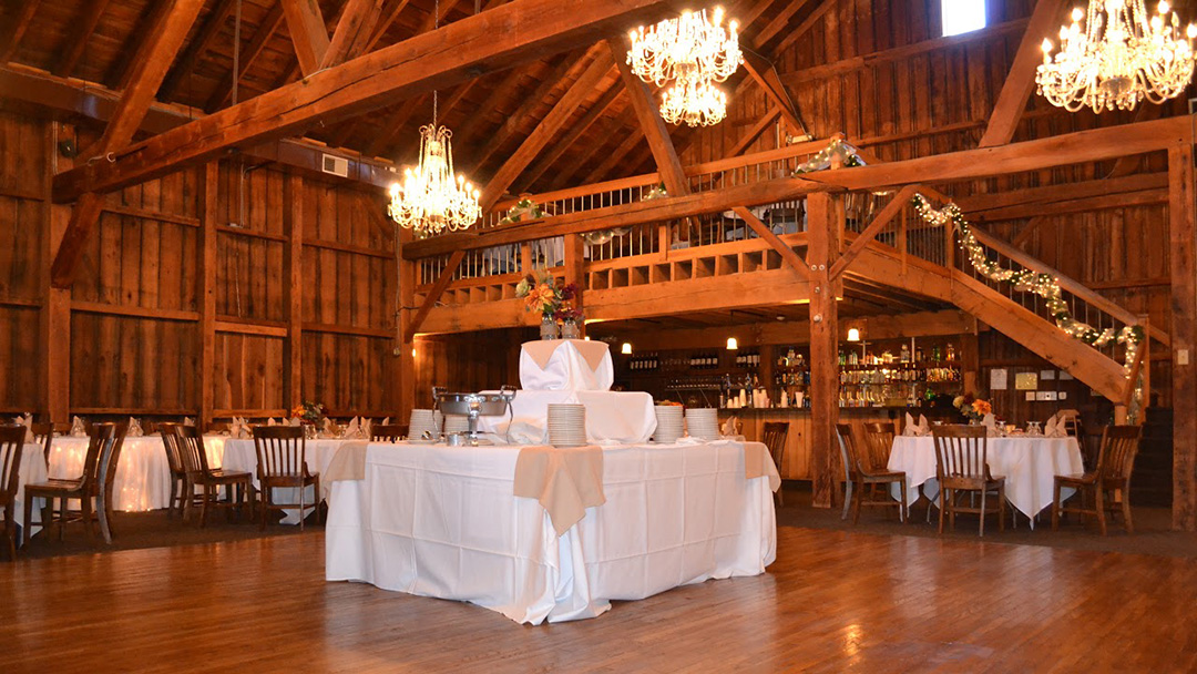 a large room with tables and chandeliers in it