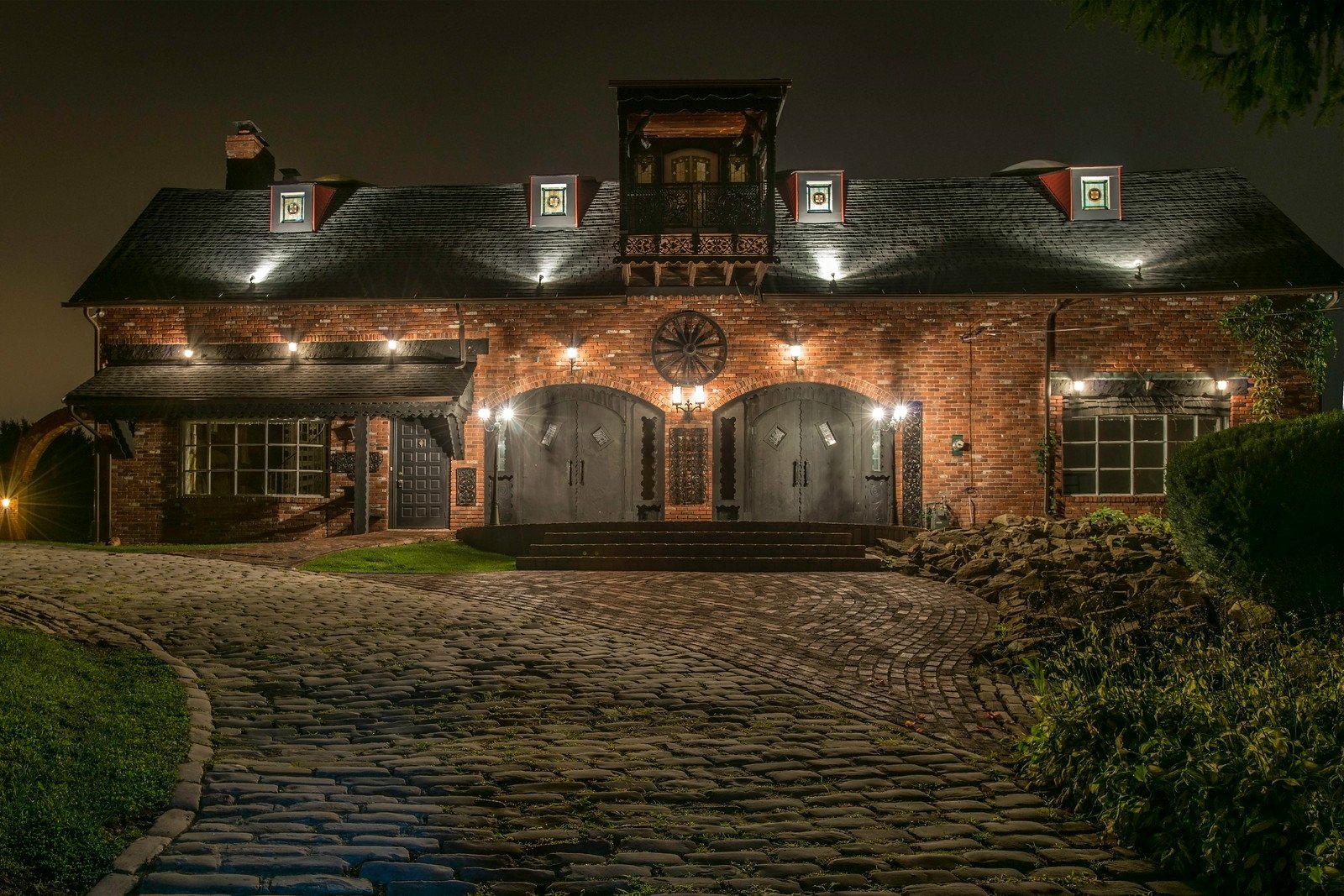 a large brick house lit up at night
