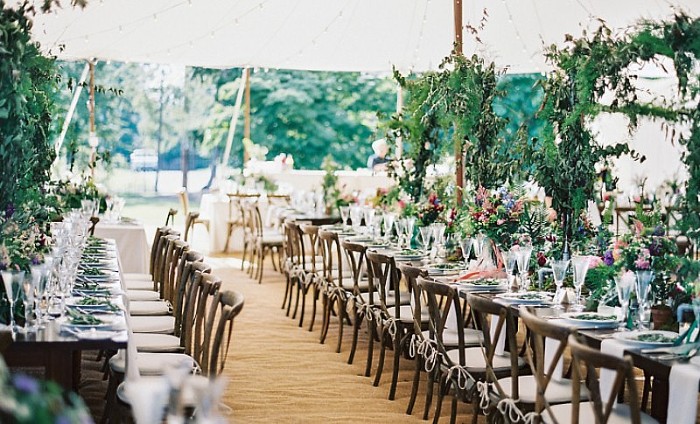 a long table set up with chairs and place settings