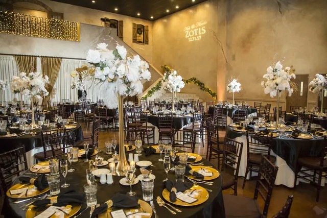 a banquet hall with tables and chairs set up for a formal function