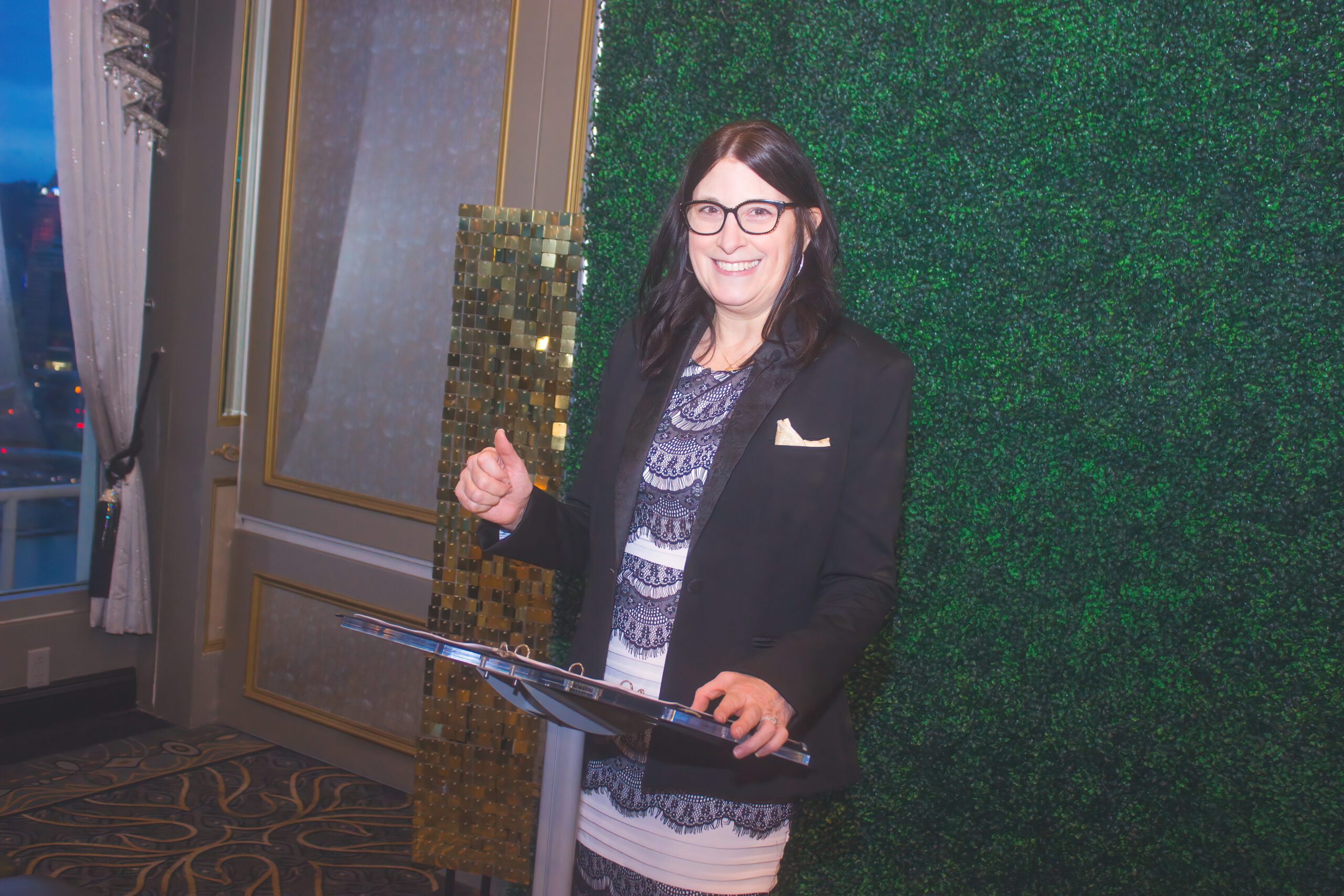 Tonya standing at a podium giving a speech