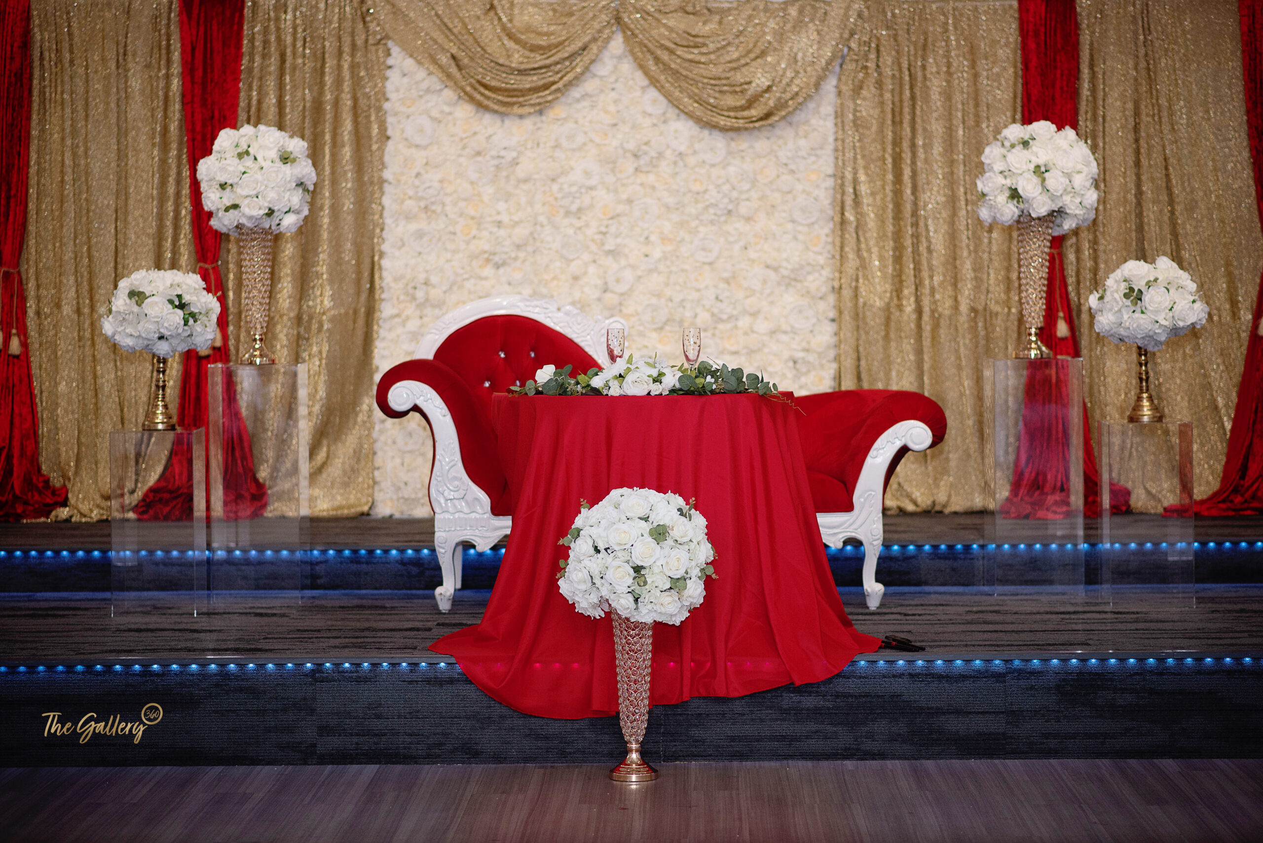 human sara wedding a red table cloth with white flowers on it and a red settee