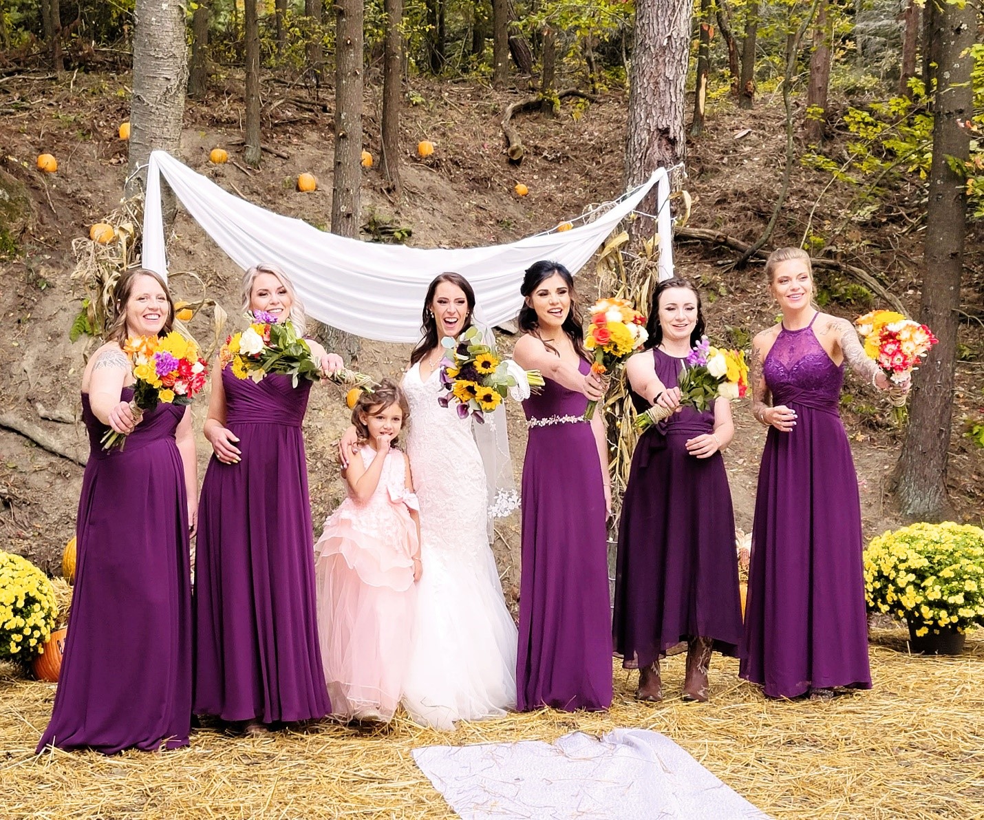 themed Weddinga group of women in purple dresses standing next to each other