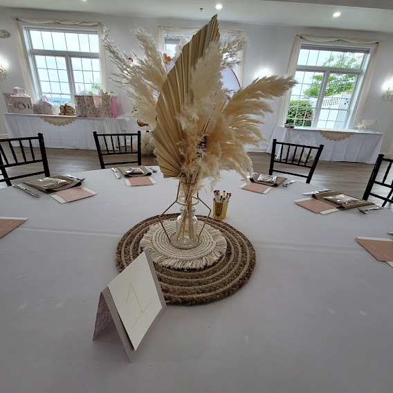 a centerpiece with feathers on top of a table