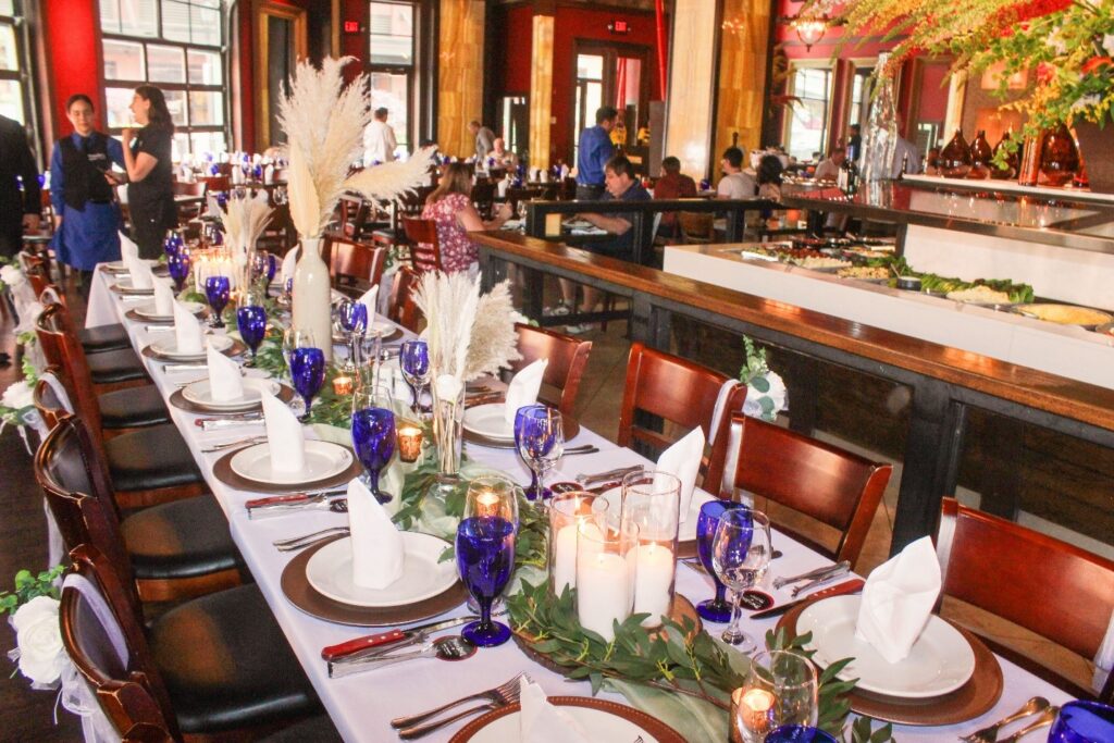 a long table with place settings and candles