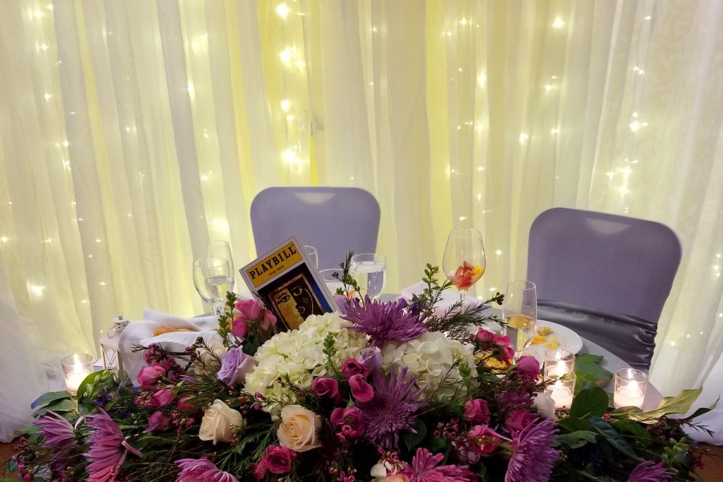 a table with purple and white flowers on it
