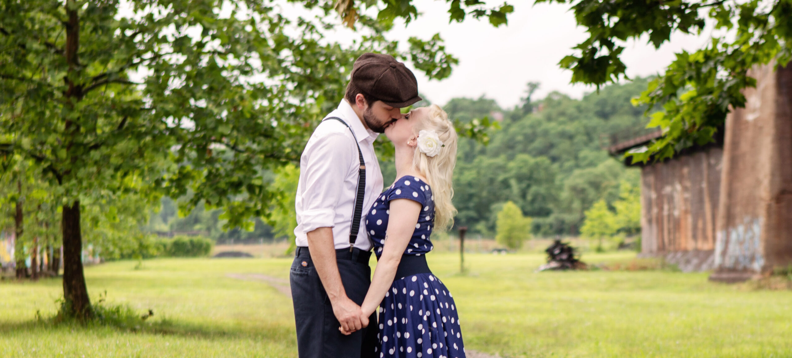 Lex and George's Engagement photos - kissing in the grass near Carrie Furnace in Pittsburgh