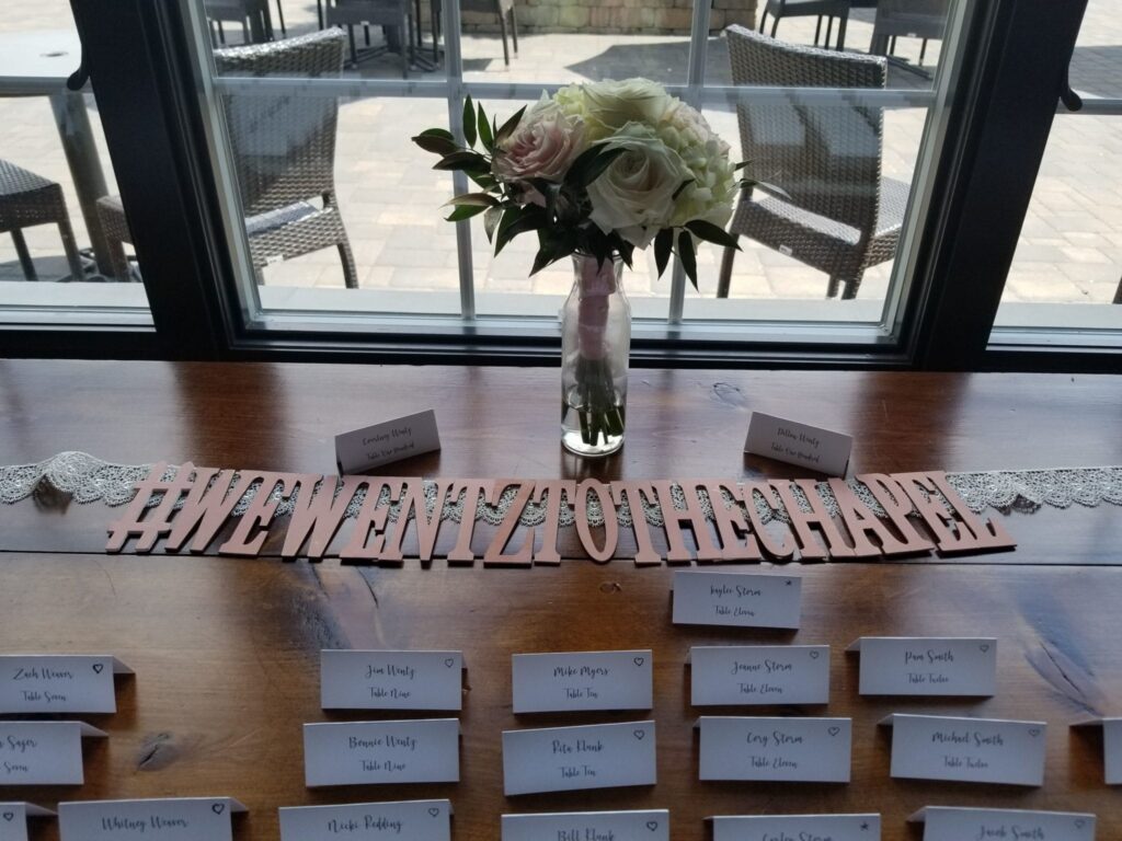 a table with place cards and a vase filled with flowers