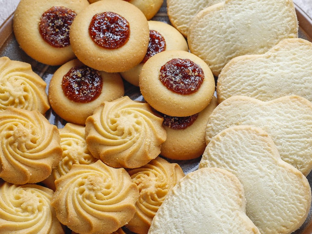 a plate full of cookies with jam on them