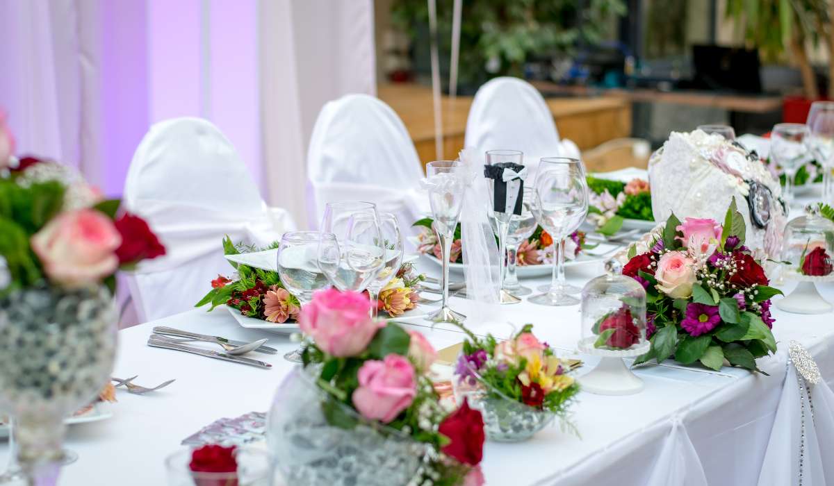a table set up with flowers and plates