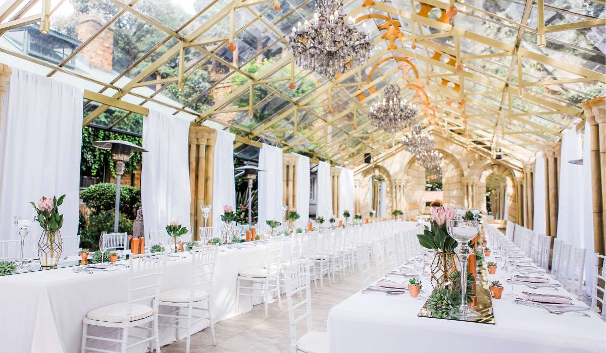 an indoor wedding venue with white tables and chairs